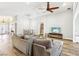 Spacious living room featuring hardwood floors, ceiling fan, neutral color palette, and comfortable sofa at 3913 Ricebird Way, North Las Vegas, NV 89084