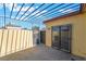 View of the back patio with concrete flooring and wrought iron pergola at 3925 Torsby Pl, Las Vegas, NV 89119