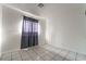 Bright bedroom features tile flooring, base molding and light entering window at 3925 Torsby Pl, Las Vegas, NV 89119