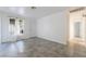 Bright bedroom with large window with decorative curtains and tiled floor adjacent to hallway at 3925 Torsby Pl, Las Vegas, NV 89119