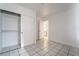 Bedroom featuring tile floors, closet, and entry to bathroom at 3925 Torsby Pl, Las Vegas, NV 89119
