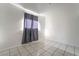 Bright bedroom features tile flooring, base molding and light entering window at 3925 Torsby Pl, Las Vegas, NV 89119