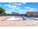 An empty in-ground pool surrounded by a concrete deck awaits renovation or filling at 3925 Torsby Pl, Las Vegas, NV 89119