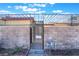 Gated front yard with brick wall and black metal gate at 3925 Torsby Pl, Las Vegas, NV 89119