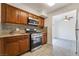 Charming kitchen features granite countertops, stainless steel appliances, and wood cabinetry at 3925 Torsby Pl, Las Vegas, NV 89119