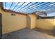 Enclosed patio with metal pergola cover, stucco walls, and stamped concrete flooring at 3925 Torsby Pl, Las Vegas, NV 89119