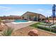 Spacious backyard with a refreshing pool, lounge chairs, a covered patio, and low-maintenance landscaping at 3966 E Garfield Dr, Pahrump, NV 89061