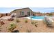 This backyard features a sparkling pool, gravel landscaping with mature cacti and a covered patio area at 3966 E Garfield Dr, Pahrump, NV 89061