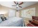 Cozy bedroom features a comfortable bed, a stylish ceiling fan, a world map and a reading nook with recliner at 3966 E Garfield Dr, Pahrump, NV 89061