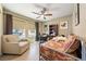 Bright bedroom with cozy armchair and lots of space; perfect for relaxing or working from home at 3966 E Garfield Dr, Pahrump, NV 89061