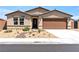 Charming single-story home with desert landscaping, neutral tones, and a two-car garage, perfect for curb appeal at 3966 E Garfield Dr, Pahrump, NV 89061
