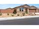 Attractive single-story home with desert landscaping and a brick perimeter wall enhances curb appeal and privacy at 3966 E Garfield Dr, Pahrump, NV 89061