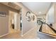 Hallway featuring neutral walls, tile floor, and view of living space with lots of natural light at 3966 E Garfield Dr, Pahrump, NV 89061