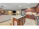 Modern kitchen features an island with a granite countertop and stainless-steel appliances at 3966 E Garfield Dr, Pahrump, NV 89061
