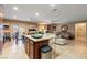 Open-concept living room with tile floors, island, and backyard access to a covered patio area at 3966 E Garfield Dr, Pahrump, NV 89061