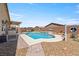 An inviting backyard with a pristine pool, spa, well-maintained landscaping, and desert surroundings at 3966 E Garfield Dr, Pahrump, NV 89061