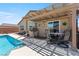 Outdoor living space with a covered patio, a built-in grill, and a refreshing pool for summer enjoyment at 3966 E Garfield Dr, Pahrump, NV 89061