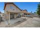 View of the back of the home and large concrete patio and block wall, with metal patio set at 4008 Lighthouse Ave, Las Vegas, NV 89110