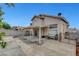 Rear view of home showing large backyard with concrete patio and covered area with metal furniture at 4008 Lighthouse Ave, Las Vegas, NV 89110