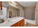 Bathroom with double sink vanity and shower-tub combo with zebra-print curtain at 4008 Lighthouse Ave, Las Vegas, NV 89110