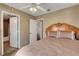 Bedroom features two doors, ceiling fan, and a large bed at 4008 Lighthouse Ave, Las Vegas, NV 89110