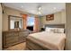 Bright bedroom featuring a large window, bed and a wood dresser at 4008 Lighthouse Ave, Las Vegas, NV 89110
