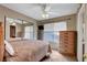 Bedroom features a large window, ceiling fan, and a dresser at 4008 Lighthouse Ave, Las Vegas, NV 89110