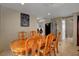 Dining room with wood table and chairs, painting, and open layout leading to laundry area at 4008 Lighthouse Ave, Las Vegas, NV 89110