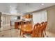 Open dining area featuring tile floors, wood table and chairs, and connection to kitchen with breakfast bar seating at 4008 Lighthouse Ave, Las Vegas, NV 89110