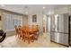 Dining area with wooden table, chairs, and stainless steel refrigerator at 4008 Lighthouse Ave, Las Vegas, NV 89110