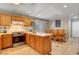Bright kitchen with a dining area featuring wooden cabinets and tile floors at 4008 Lighthouse Ave, Las Vegas, NV 89110