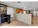 Open kitchen featuring tile floors, bar seating, and a liquor cabinet at 4008 Lighthouse Ave, Las Vegas, NV 89110