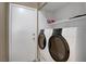 Functional laundry room with modern washer and dryer units and shelving for storage at 4008 Lighthouse Ave, Las Vegas, NV 89110