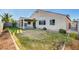 Large backyard with a covered patio area, complemented by a well-maintained lawn, shrubs, and providing space for outdoor activities at 4331 Golden Palomino Ln, North Las Vegas, NV 89032