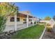 Spacious backyard features a covered patio, perfect for outdoor living and dining, with a well-maintained lawn and block fencing at 4331 Golden Palomino Ln, North Las Vegas, NV 89032
