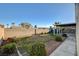 Spacious backyard featuring a covered patio area, complemented by a well-maintained lawn, and privacy block fencing at 4331 Golden Palomino Ln, North Las Vegas, NV 89032