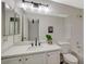 Bathroom featuring a large mirror, vanity with white cabinets, and bath-shower combo at 4331 Golden Palomino Ln, North Las Vegas, NV 89032