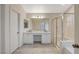 Bathroom featuring double sinks, white cabinets, and shower over tub at 4331 Golden Palomino Ln, North Las Vegas, NV 89032