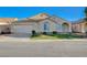 Charming single-story home with a well-maintained lawn, desert landscaping and a two car garage at 4331 Golden Palomino Ln, North Las Vegas, NV 89032