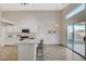 Spacious kitchen featuring white cabinets, stainless steel appliances, and a breakfast bar at 4331 Golden Palomino Ln, North Las Vegas, NV 89032