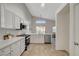 Bright kitchen featuring white cabinets, stainless appliances, and wood-look tile flooring at 4331 Golden Palomino Ln, North Las Vegas, NV 89032