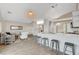 Open-concept kitchen and living area with wood-look tile flooring and modern design at 4331 Golden Palomino Ln, North Las Vegas, NV 89032