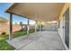 A covered patio featuring concrete flooring, creating a relaxing outdoor space surrounded by a well-maintained yard and privacy wall at 4331 Golden Palomino Ln, North Las Vegas, NV 89032