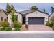 Charming single-story home features a brick driveway, neutral stucco, and a dark gray two-car garage door at 4356 E Cactus Canyon Dr, Pahrump, NV 89061