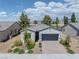 Charming single-story home featuring a two-car garage, brick driveway, and well-manicured landscaping at 4356 E Cactus Canyon Dr, Pahrump, NV 89061