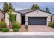 Charming single-story home features a brick driveway, neutral stucco, and a dark gray two-car garage door at 4356 E Cactus Canyon Dr, Pahrump, NV 89061