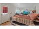 Comfortable bedroom featuring a large bed, natural light, and entertainment setup at 4602 Inland Ct, Las Vegas, NV 89147