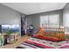 Comfortable bedroom with ample natural light, featuring a crib and warm decor at 4602 Inland Ct, Las Vegas, NV 89147