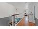 Upstairs hallway with hardwood floors, white railing, and view of the bedroom at 4602 Inland Ct, Las Vegas, NV 89147
