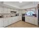 Functional kitchen featuring white cabinets, tiled backsplash, and modern appliances at 4602 Inland Ct, Las Vegas, NV 89147
